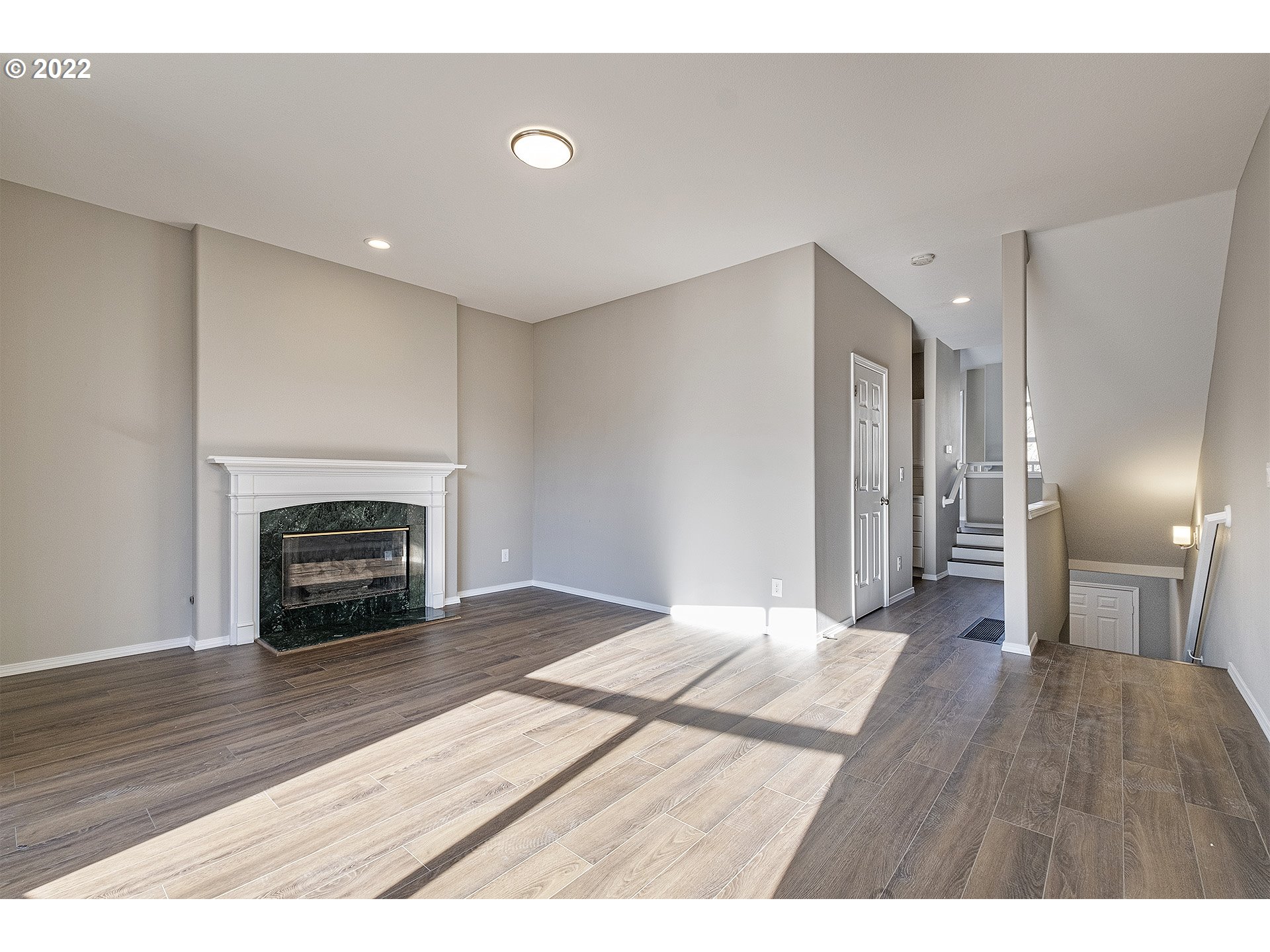 15718 Southwest Flagstone Drive Beaverton, OR 97007 - Photo 4 of 32 a empty room with a fireplace and wooden floor