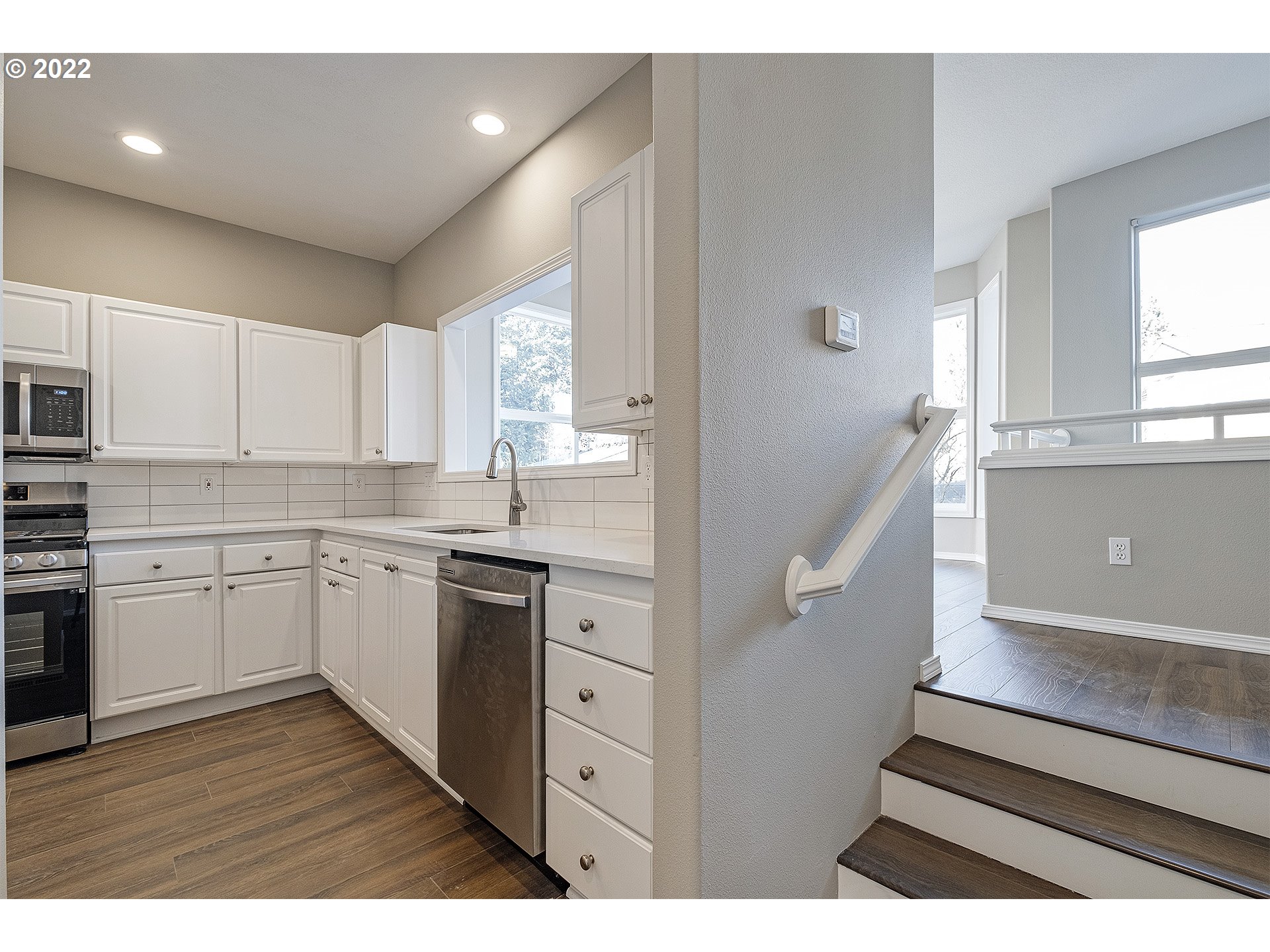 15718 Southwest Flagstone Drive Beaverton, OR 97007 - Photo 7 of 32 a kitchen with cabinets appliances and a window