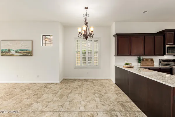 a view of kitchen with refrigerator and window