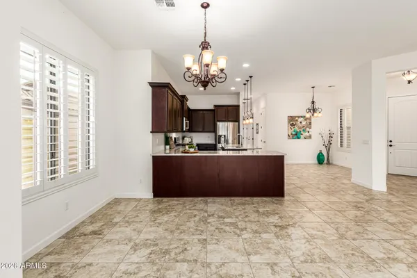 a kitchen with granite countertop a refrigerator and a stove top oven