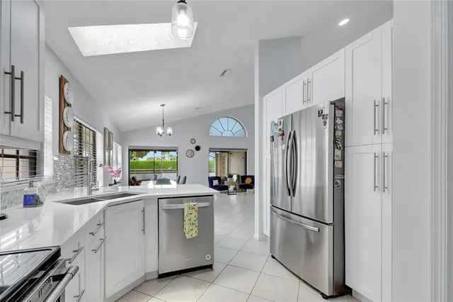a kitchen with a refrigerator a sink and dishwasher