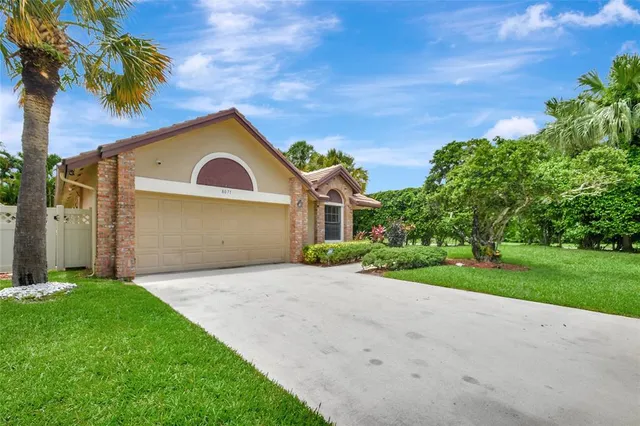 a front view of a house with a yard and garage