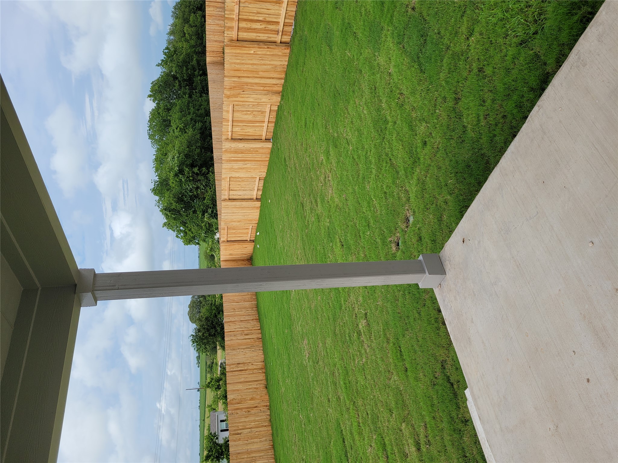131 Wild Wind Cove Jarrell, TX 76537 - Photo 11 of 26 Expansive backyard featuring a concrete patio, a full privacy fence, and a manicured lawn