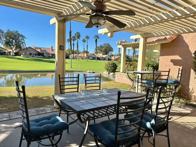 a view of a patio with a table chairs and a table