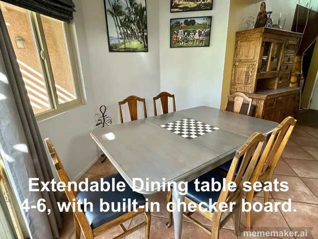 a view of a dining room with furniture and a window