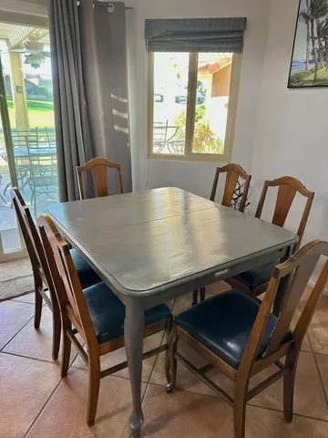 a view of a dining room with furniture and a large window