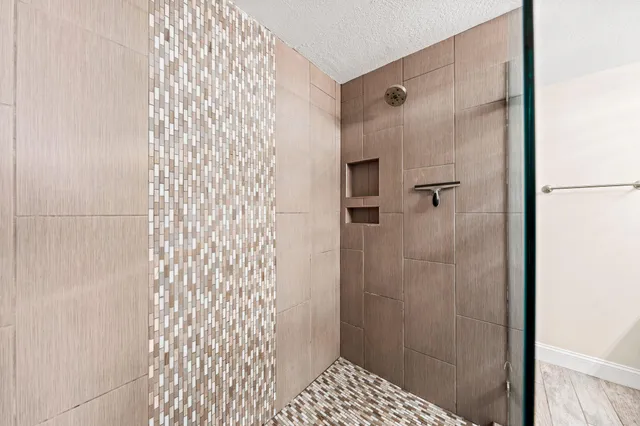 a bathroom with a shower and a sink