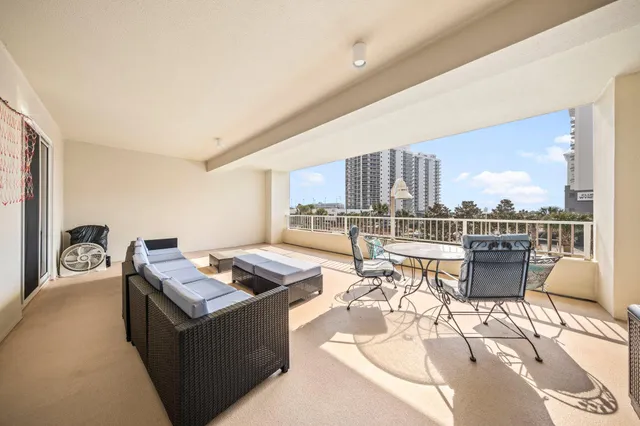 a living room with furniture a rug and white walls