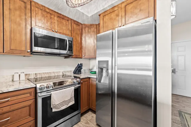 a kitchen with a refrigerator stove and microwave