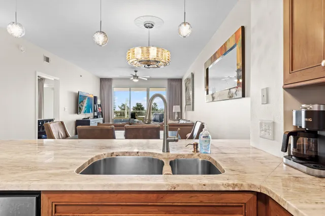 a view with kitchen island a sink and living room view