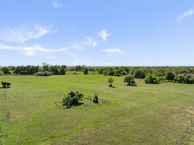 a view of a field with an ocean