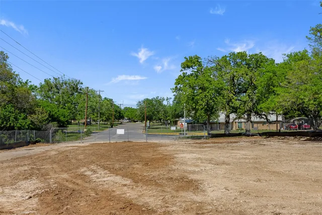 a backyard of a house with lots of green space and fountain