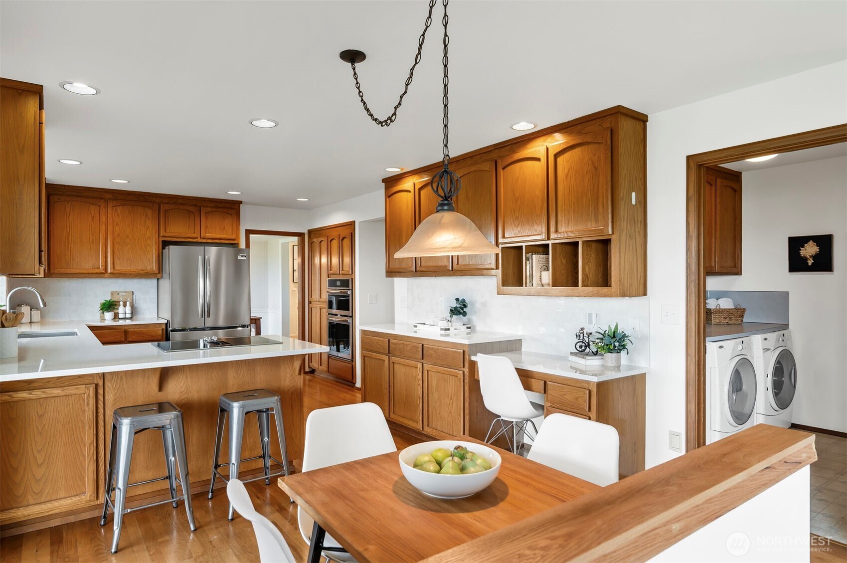 4631 View Drive Everett, WA 98203 - Photo 20 of 40 a kitchen with stainless steel appliances granite countertop a table chairs and a refrigerator