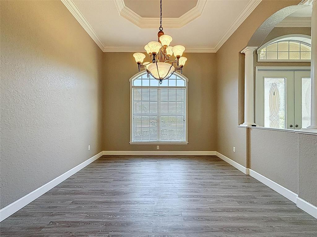 11235 Warm Wind Way Weeki Wachee, FL 34613 - Photo 13 of 93 a view of an empty room with wooden floor and fan