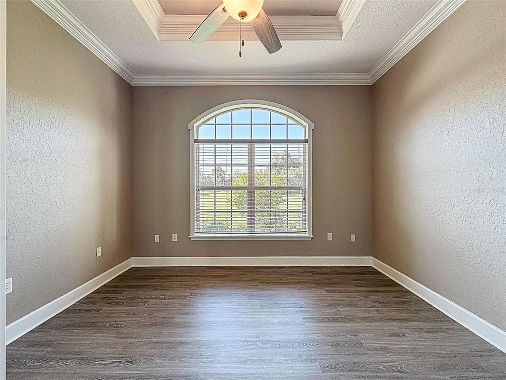 11235 Warm Wind Way Weeki Wachee, FL 34613 - Photo 15 of 93 an empty room with wooden floor and windows
