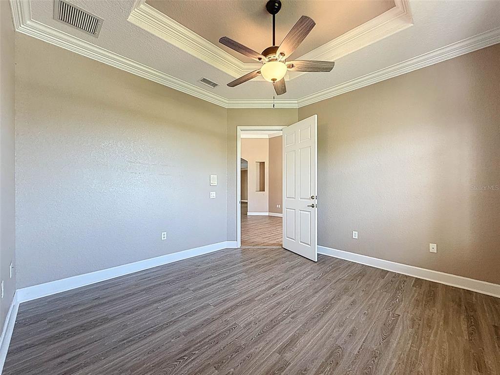 11235 Warm Wind Way Weeki Wachee, FL 34613 - Photo 16 of 93 a view of an empty room with wooden floor
