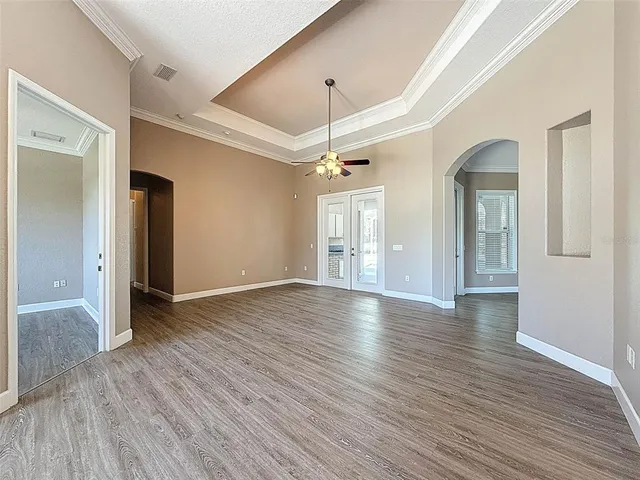 a view of a livingroom with a fireplace wooden floor and chandelier