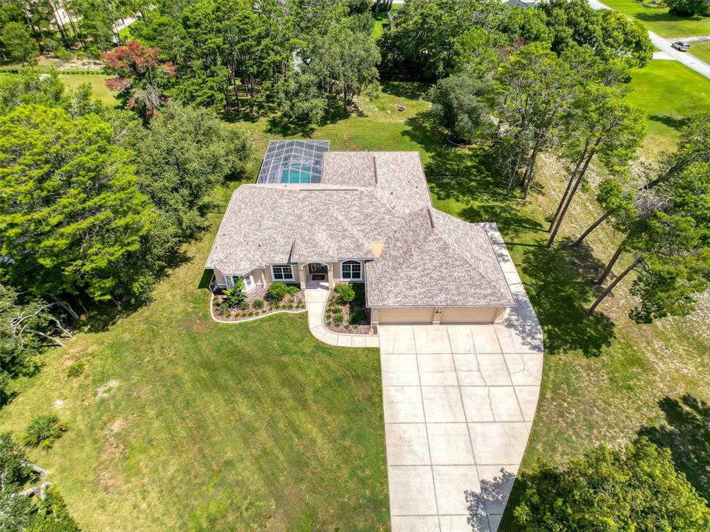 11235 Warm Wind Way Weeki Wachee, FL 34613 - Photo 3 of 93 an aerial view of a house with swimming pool and large trees