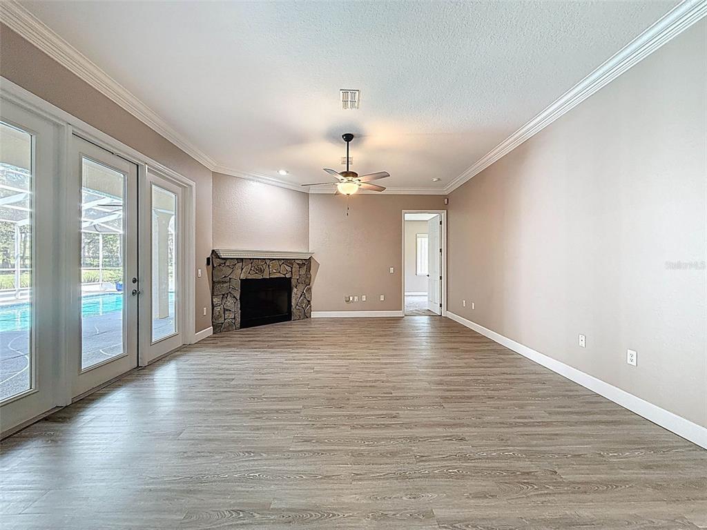 11235 Warm Wind Way Weeki Wachee, FL 34613 - Photo 31 of 93 a view of a livingroom with a ceiling fan window and wooden floor