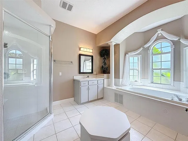a room with a sink a window and wooden floor