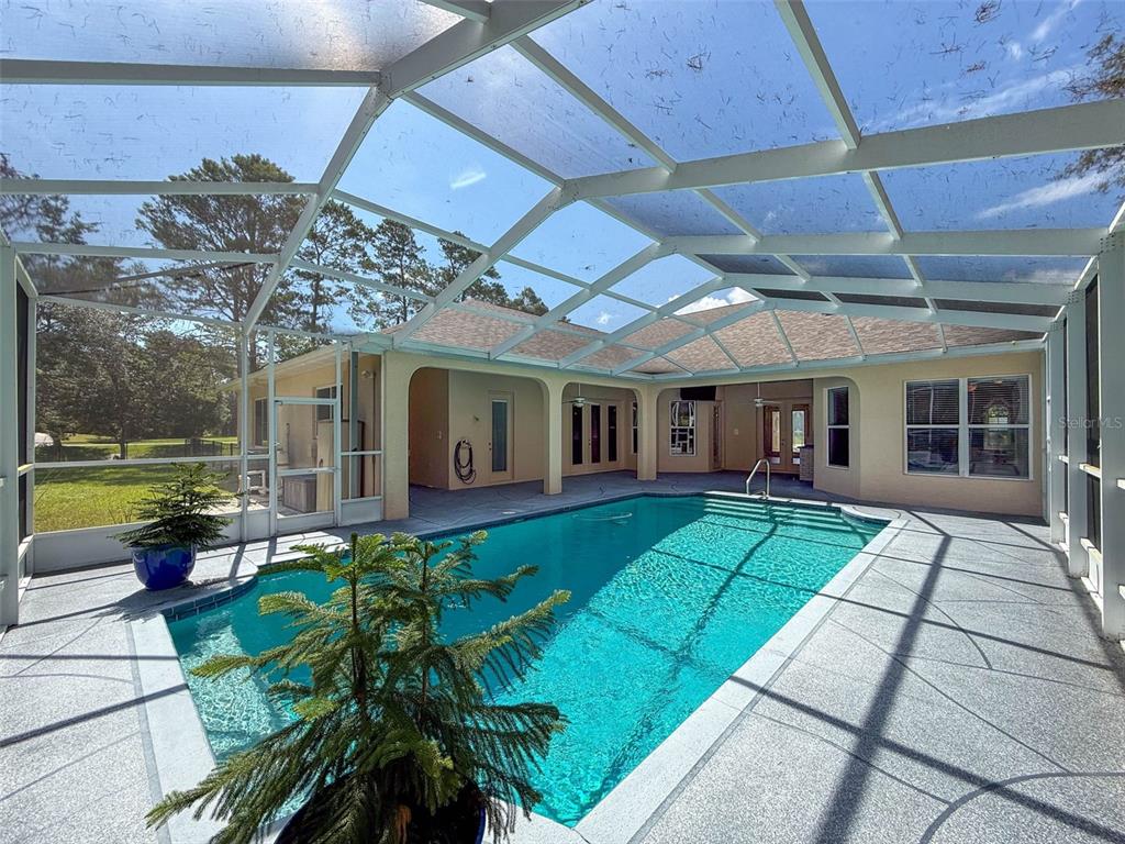 11235 Warm Wind Way Weeki Wachee, FL 34613 - Photo 4 of 93 a view of a house with backyard sitting area and swimming pool