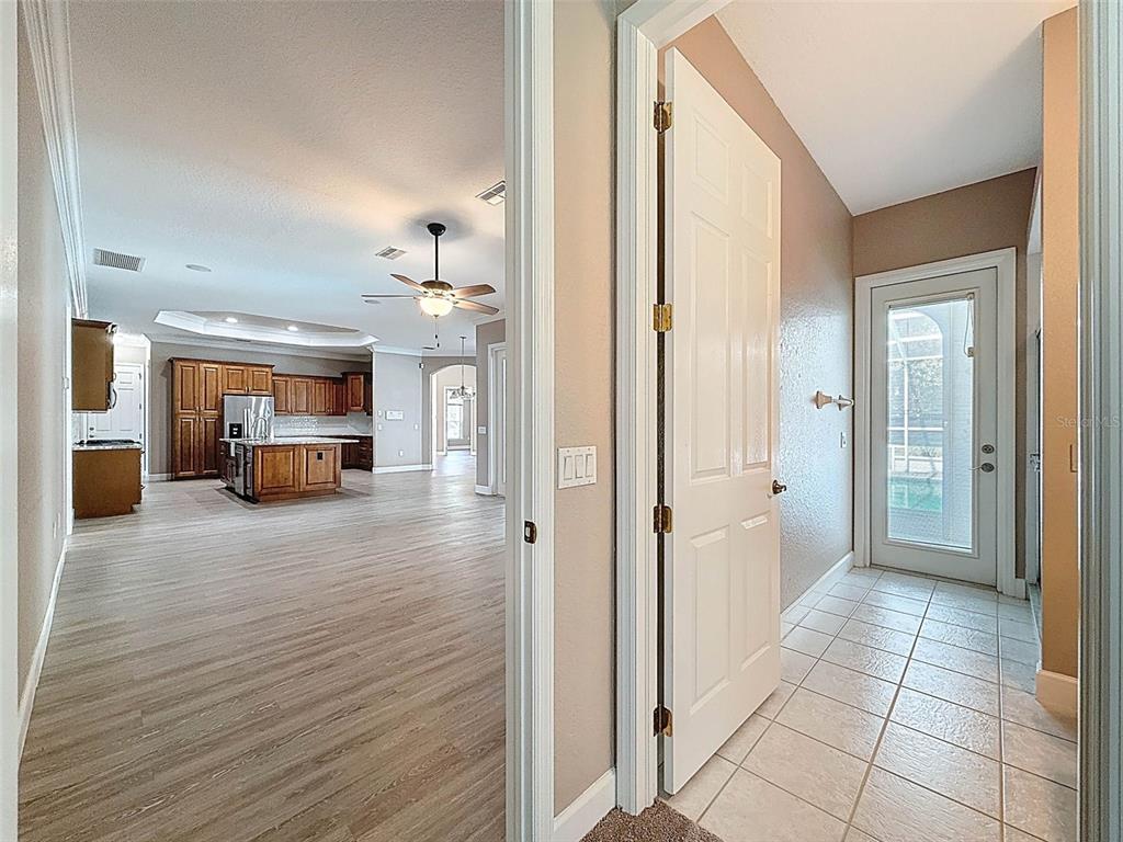 11235 Warm Wind Way Weeki Wachee, FL 34613 - Photo 55 of 93 a view of a hallway view with wooden floor and a living room
