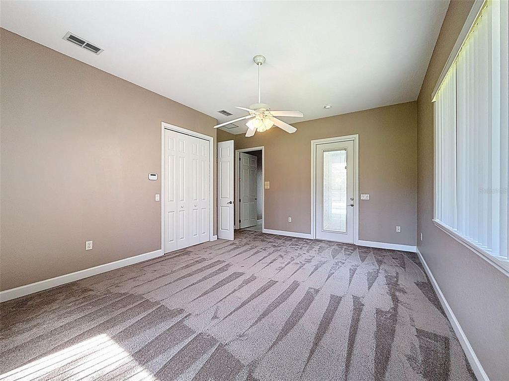 11235 Warm Wind Way Weeki Wachee, FL 34613 - Photo 59 of 93 a view of an empty room with wooden floor and window