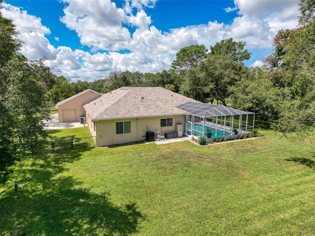 11235 Warm Wind Way Weeki Wachee, FL 34613 - Photo 66 of 93 a front view of a house with a garden