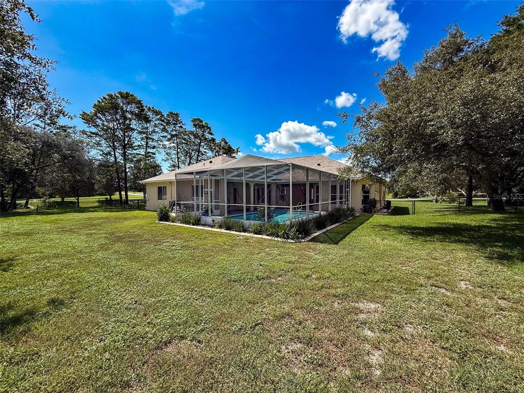 11235 Warm Wind Way Weeki Wachee, FL 34613 - Photo 67 of 93 a view of a house with a big yard
