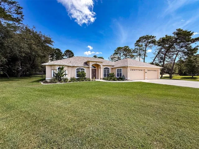 an empty room with wooden floor chandelier fan and windows
