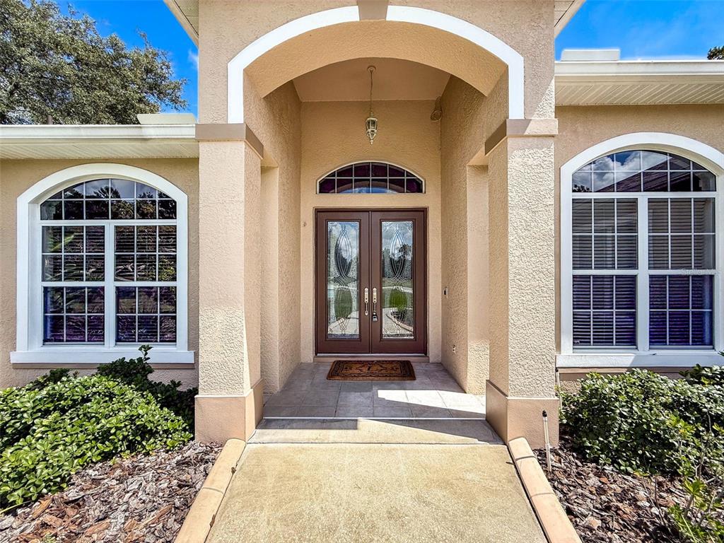 11235 Warm Wind Way Weeki Wachee, FL 34613 - Photo 8 of 93 a front view of a house with large windows