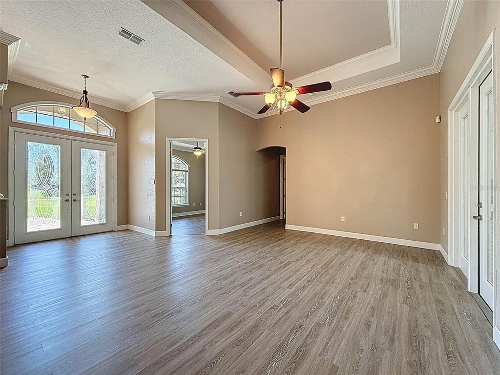 11235 Warm Wind Way Weeki Wachee, FL 34613 - Photo 10 of 93 a view of an empty room with wooden floor and a window