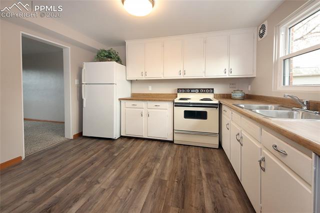 2419 Paseo Road Colorado Springs, CO 80907 - Photo 2 of 23 New flooring and an abundance of cabinets in the eat-in kitchen