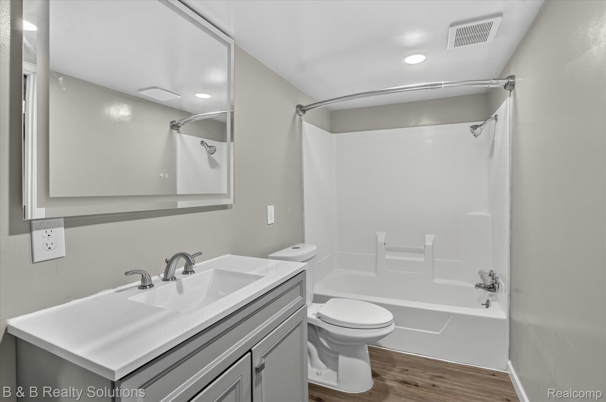 1564 East Burnside Road North Branch, MI 48461 - Photo 11 of 25 Bathroom featuring a light gray vanity with an integrated sink, brushed nickel faucet, and a large mirror