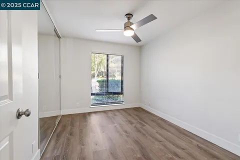 a bedroom with bed and wooden floor