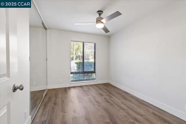 a bedroom with bed and wooden floor