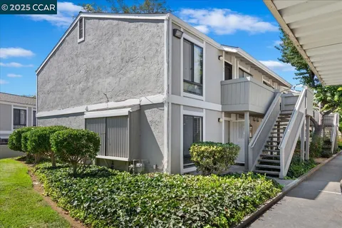 a view of a house with a flower garden