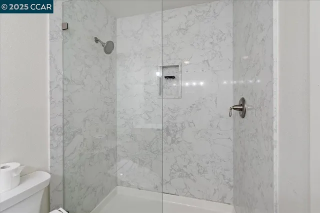 a view of a house with wooden stairs and a small yard