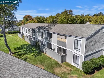 a view of a house with pool and chairs