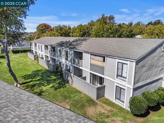 a view of a house with pool and chairs