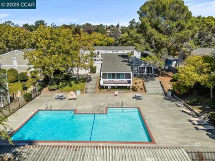 an aerial view of a house with yard swimming pool and outdoor seating