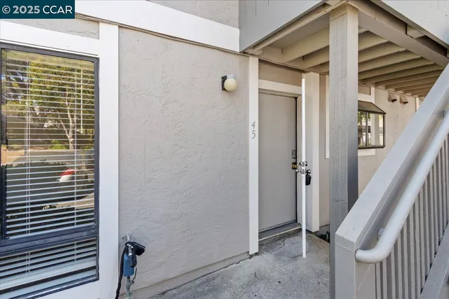 a kitchen with wooden cabinets a stove a sink and a window