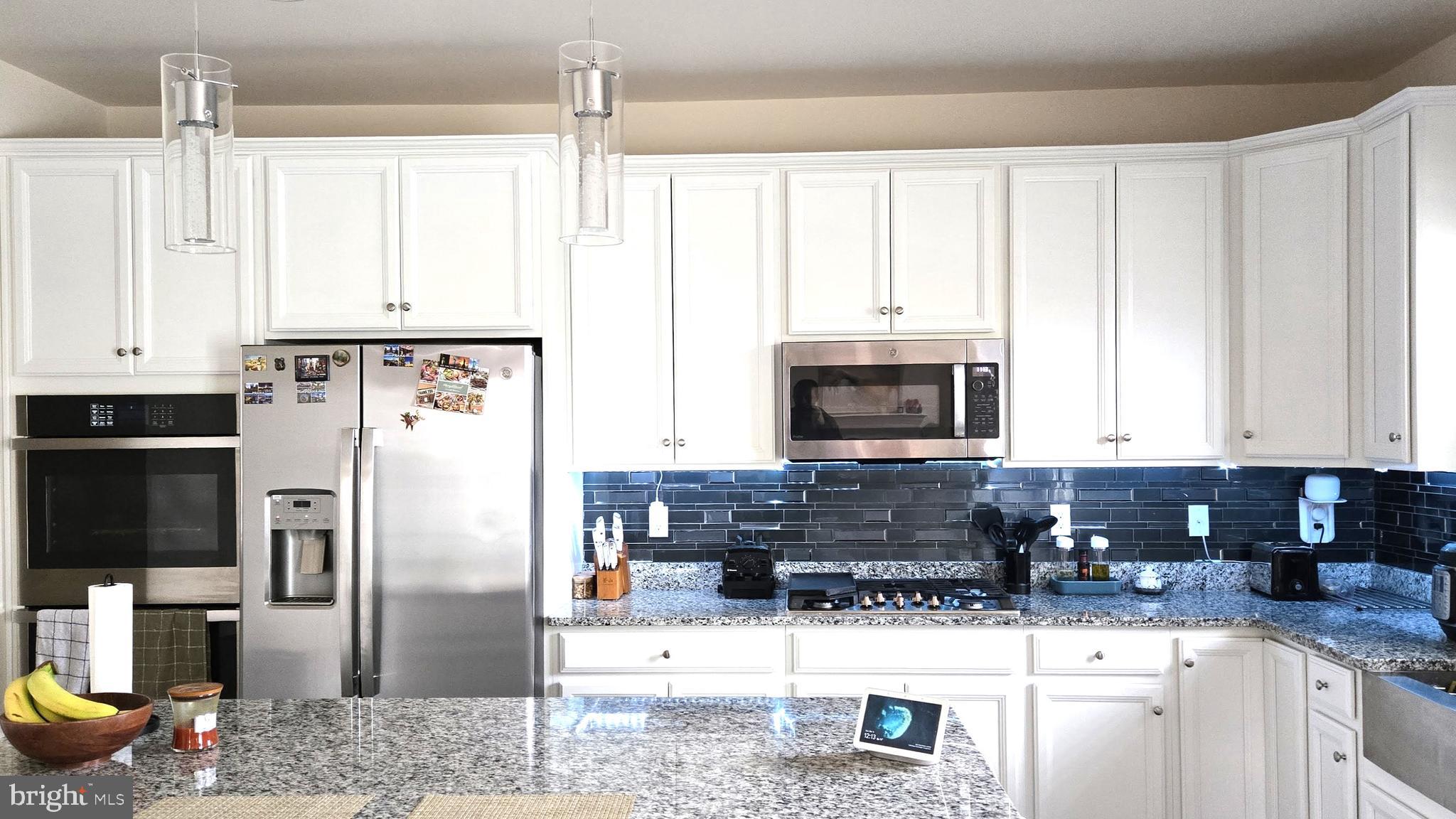 602 Rigel Way Bear, DE 19701 - Photo 12 of 28 a kitchen with stainless steel appliances granite countertop a refrigerator a stove a sink and dishwasher