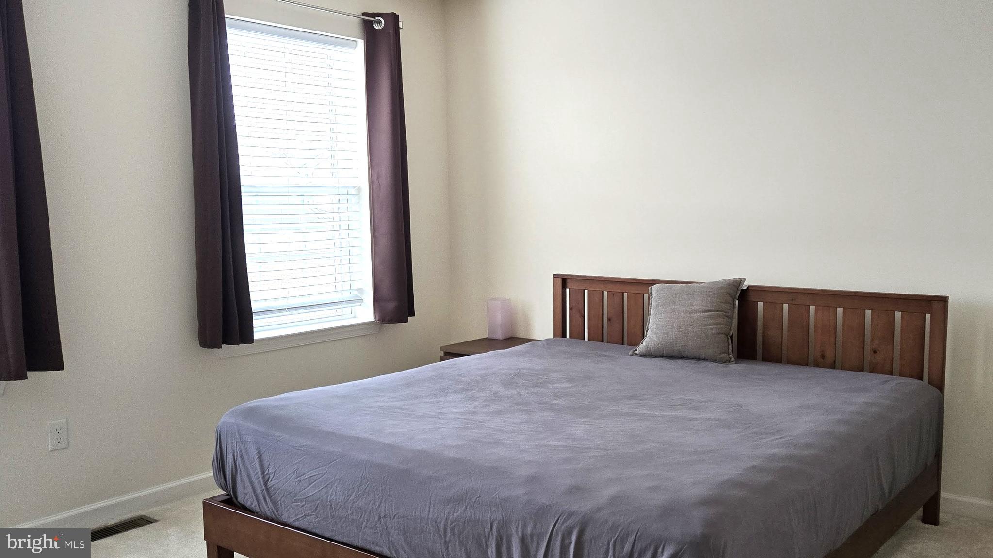 602 Rigel Way Bear, DE 19701 - Photo 22 of 28 a large bed sitting in a bedroom next to a window