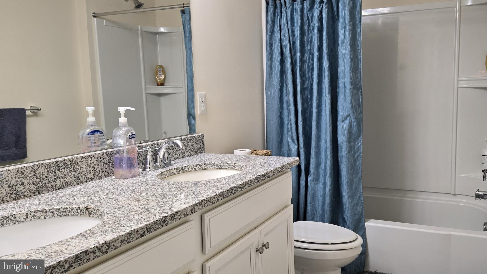 602 Rigel Way Bear, DE 19701 - Photo 24 of 28 a bathroom with a granite countertop sink a toilet a mirror and shower