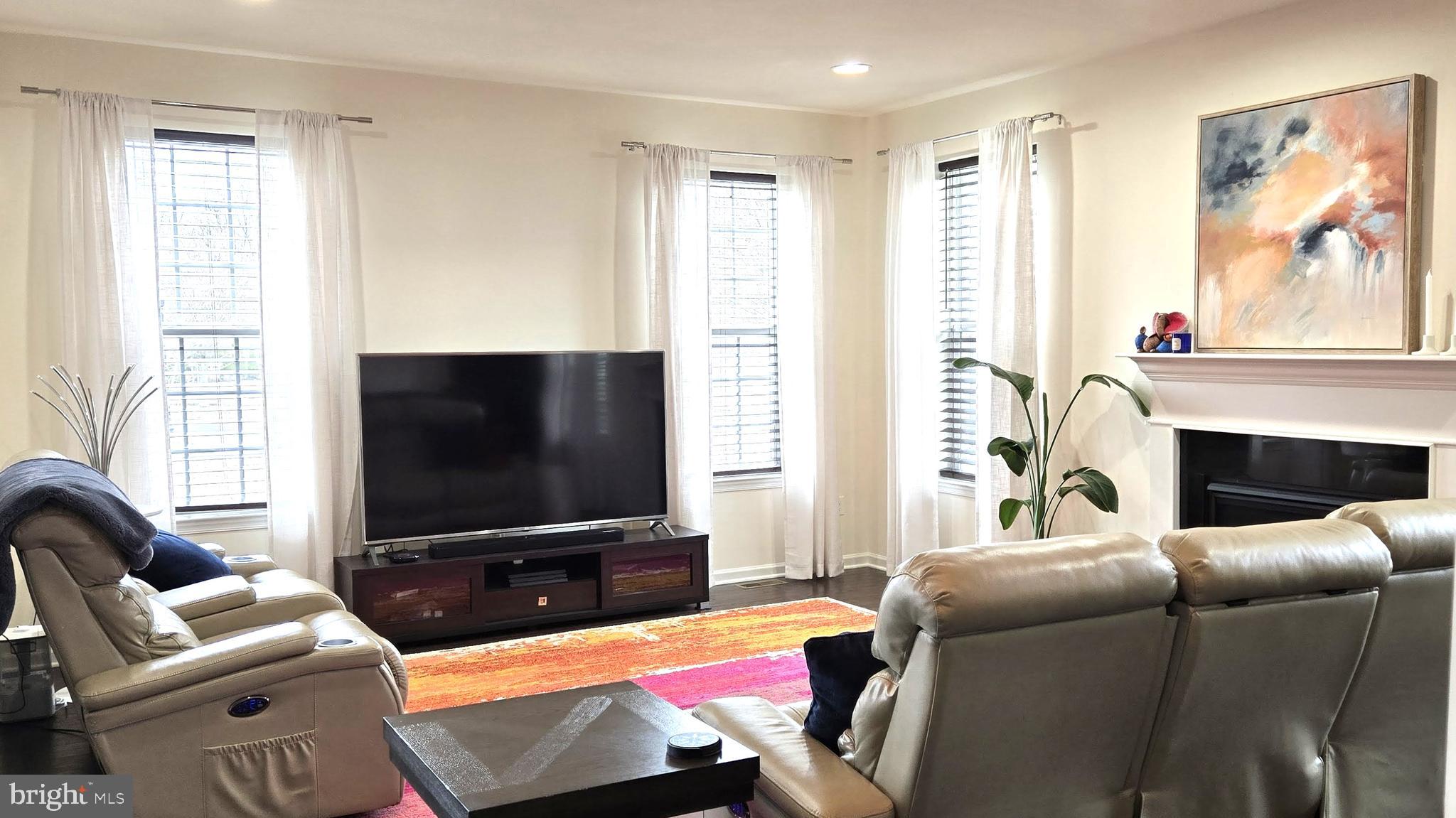 602 Rigel Way Bear, DE 19701 - Photo 7 of 28 a living room with furniture a flat screen tv and a floor to ceiling window