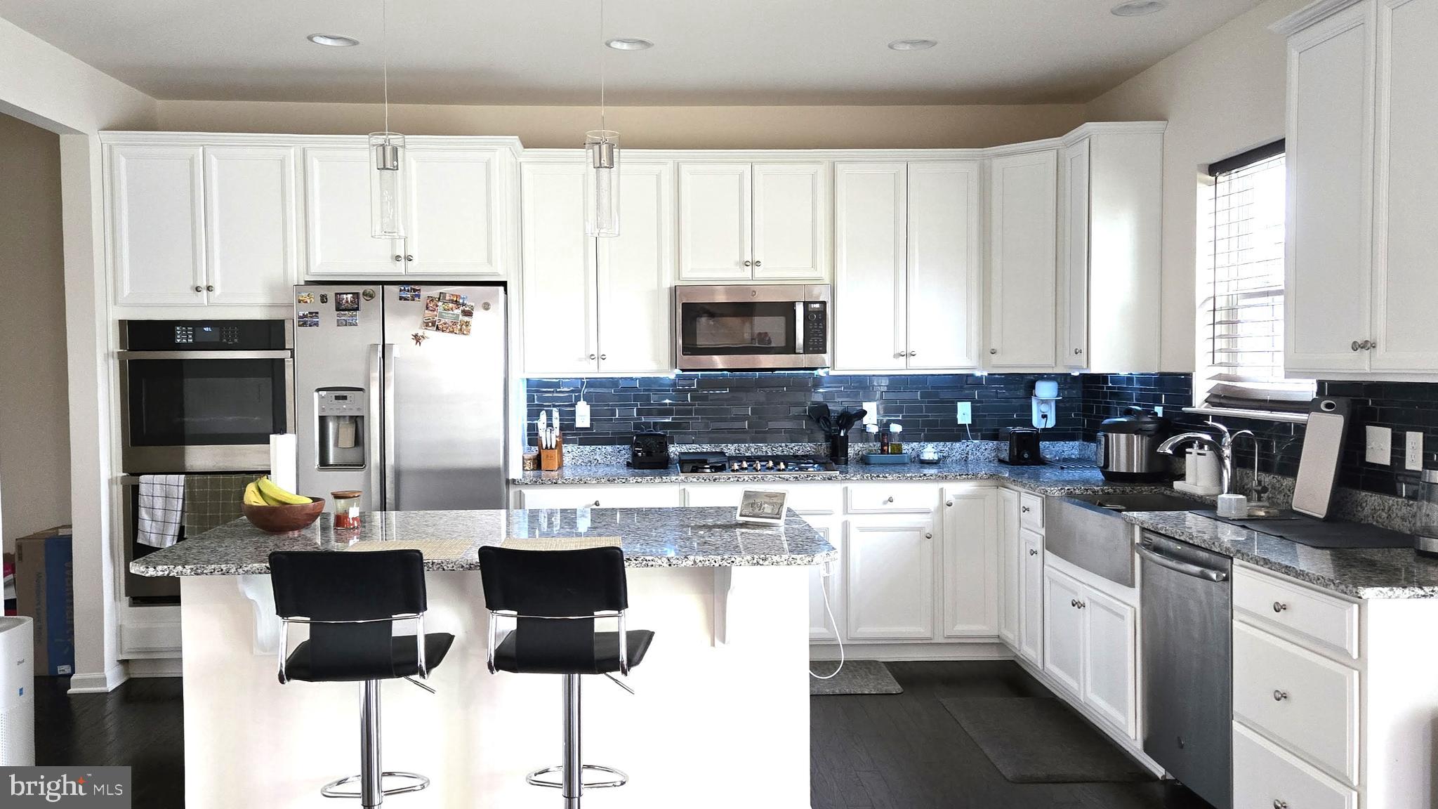 602 Rigel Way Bear, DE 19701 - Photo 10 of 28 a kitchen with a refrigerator a stove a microwave and cabinets