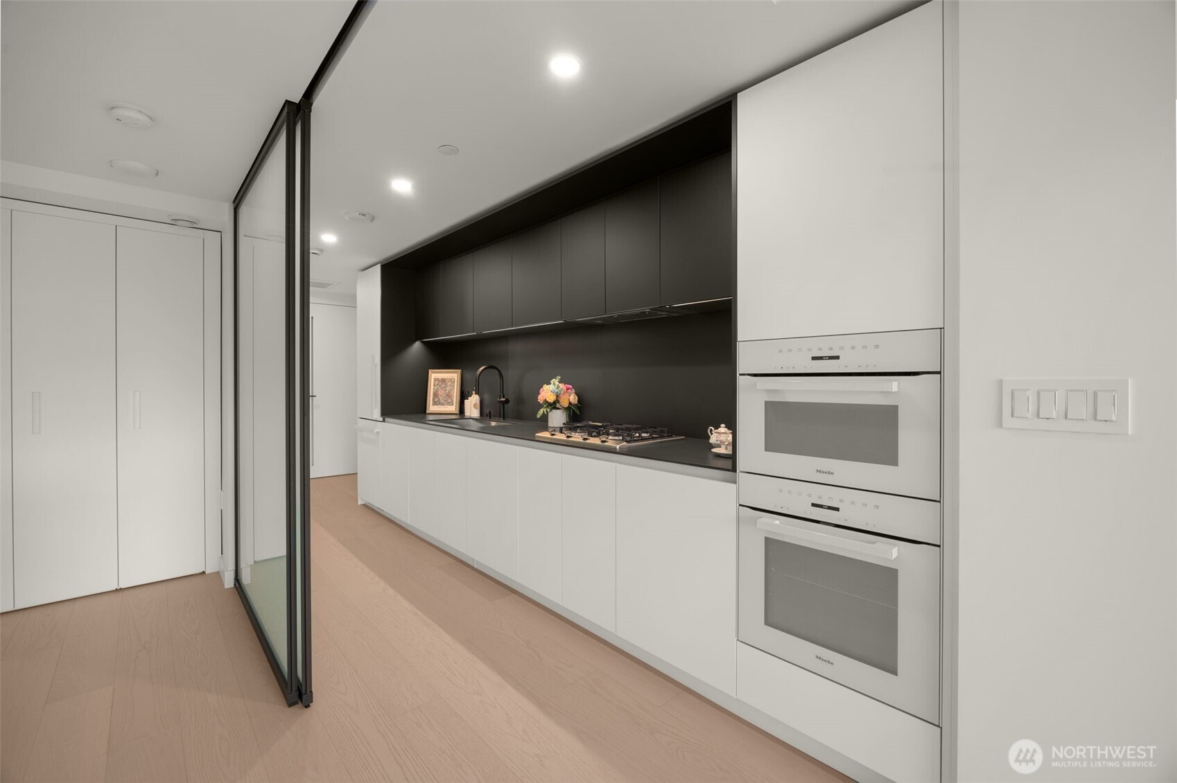 300 Virginia Street, Unit 3607 Seattle, WA 98101 - Photo 14 of 37 a kitchen with white cabinets and stainless steel appliances