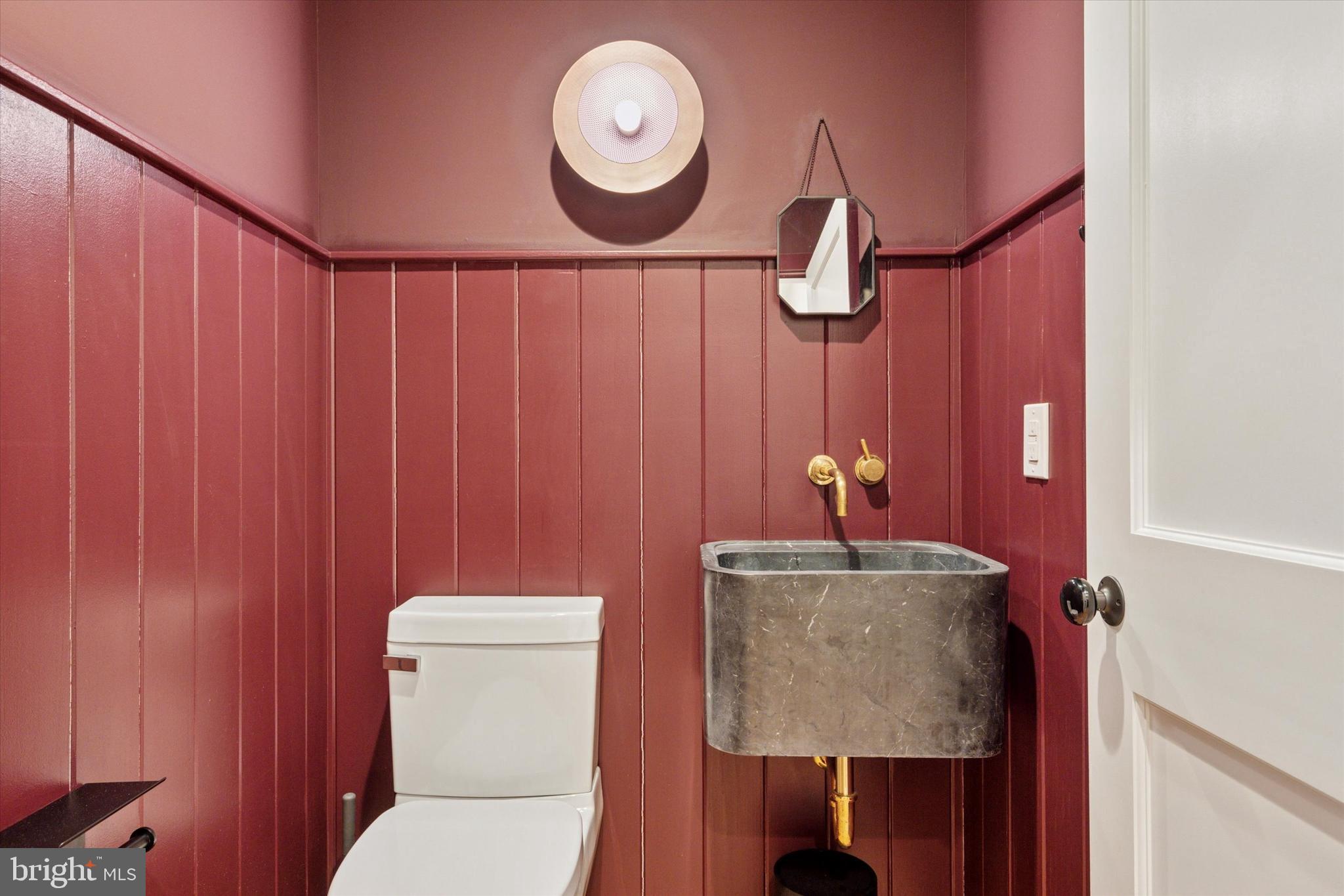 1725-27 Addison Street Philadelphia, PA 19146 - Photo 15 of 43 a bathroom with a toilet a sink and mirror