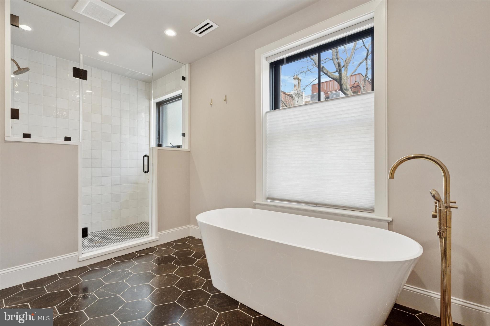 1725-27 Addison Street Philadelphia, PA 19146 - Photo 20 of 43 a white bath tub sitting in a bathroom